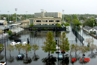 After Katrina, floodwaters create a lake at the athletics complex on the uptown campus, covering tennis courts and practice fields and surrounding the Wilson Center. (Photo from Katrina Remembered exhibit)