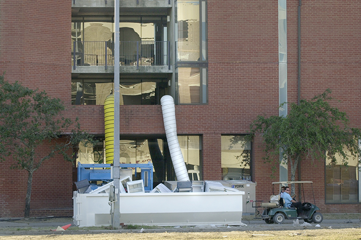 A dumpster filled with discarded refrigerators sits outside the Willow Residence Hall. A dumpster filled with discarded refrigerators sits outside the Willow Residence Hall.