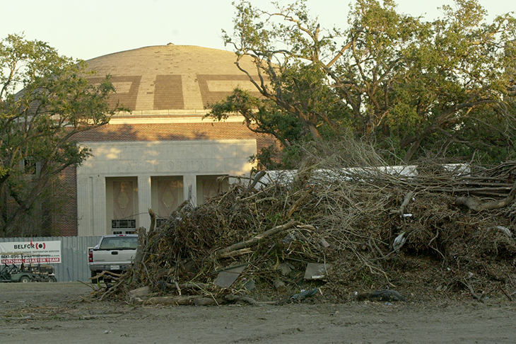 The front view of McAlister Auditorium is blocked by debris piled high on the University Center quad.
