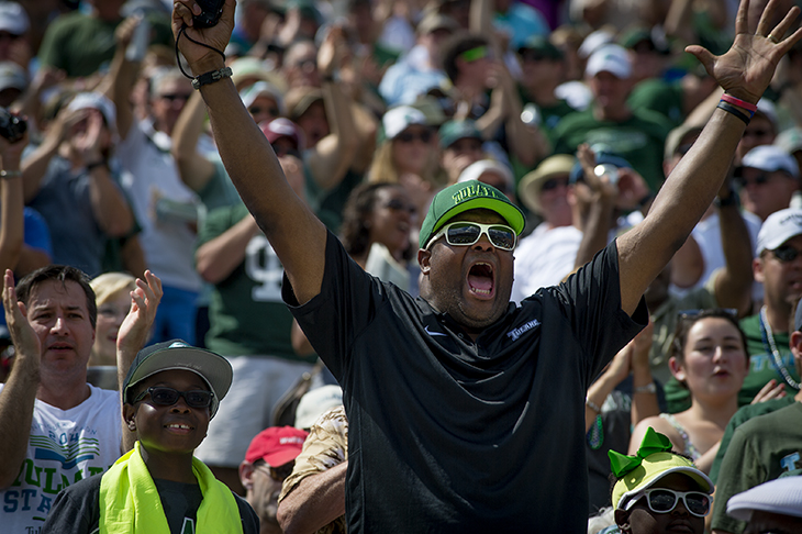 A Tulane fan passionately roots for the Green Wave.