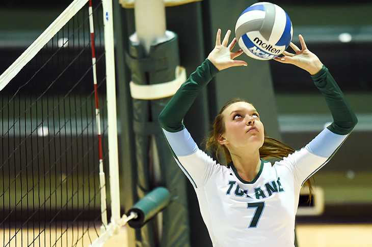 Green Wave volleyball sets up for a win.