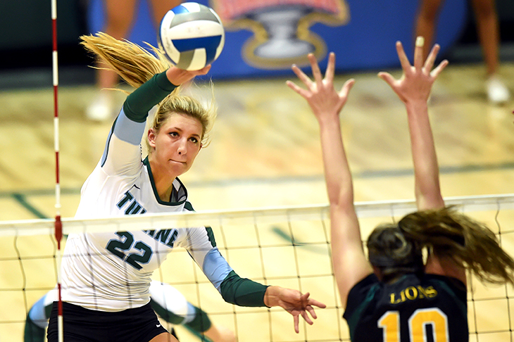 Green Wave volleyball sets up for a win.