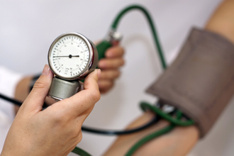 Doctor takes a patient's blood pressure.