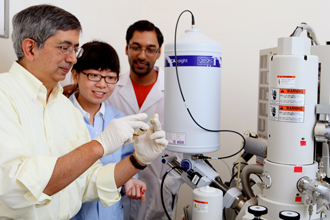 Vijay John reviews oil samples with graduate students Jingjian Tang and Pradeep Venkataraman.