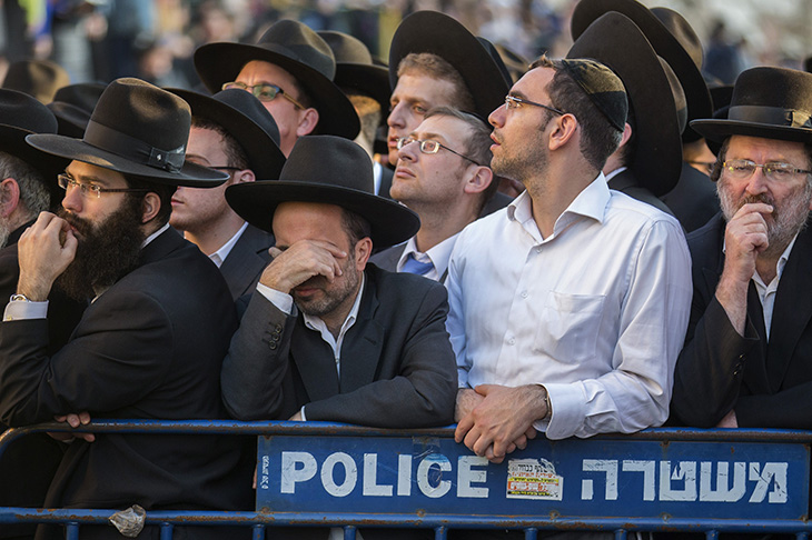 Ultra-Orthodox Jews mourn over the bodies of three of the victims of an attack on Nov. 18 at a synagogue in the Har Nof neighborhood in Jerusalem. (Photo by Jack Guez/AFP/Getty Images)