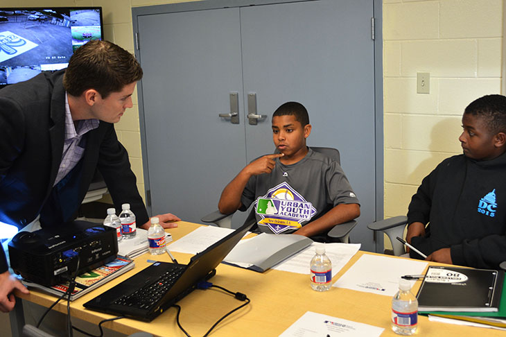 Hamilton Wise, who is in the JD/MBA class of 2016, talks baseball business with 12-year-olds Alfred Ripoll IV and Andreas Palmer