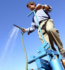 Martin Fisher demonstrates a pedal-powered water pump for use in farming.