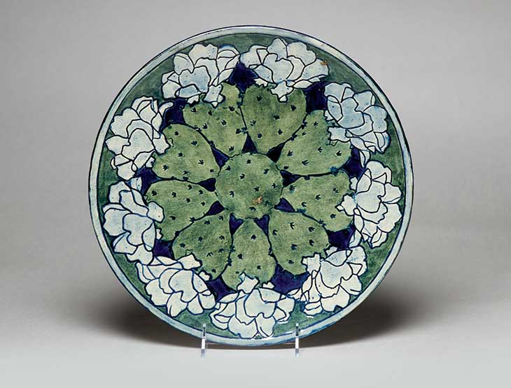 This Newcomb Pottery piece, decorated by Harriet Coulter Jool in 1903, bears the image of a blooming cactus. 