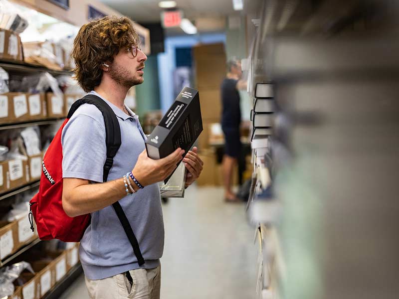 Law student Charles Copetas searches the bookshelves at the Tulane University bookstore for textbooks.