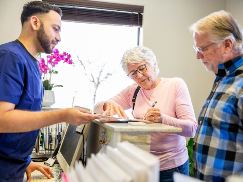 A couple fills out medical paperwork