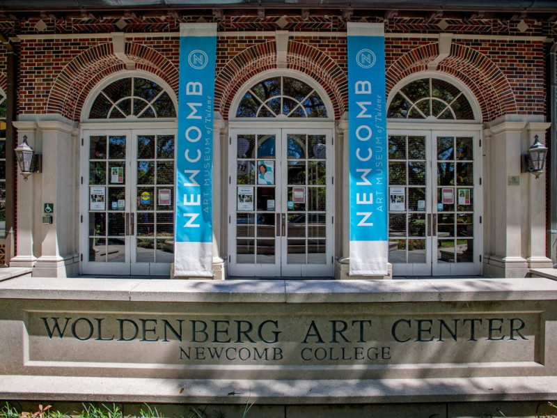 Woldenberg Art Center entrance with arched doors and "Newcomb" banners.