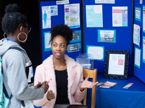 A student explains their project to another student. 
