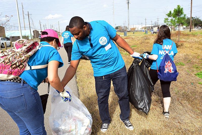 Tulane sophomore Bri'anna Lowe, left, and graduate student Luc Ngassam pick up litter along the Lafitte Greenway. Volunteers from local universities unite to honor Dr. Martin Luther King, Jr.