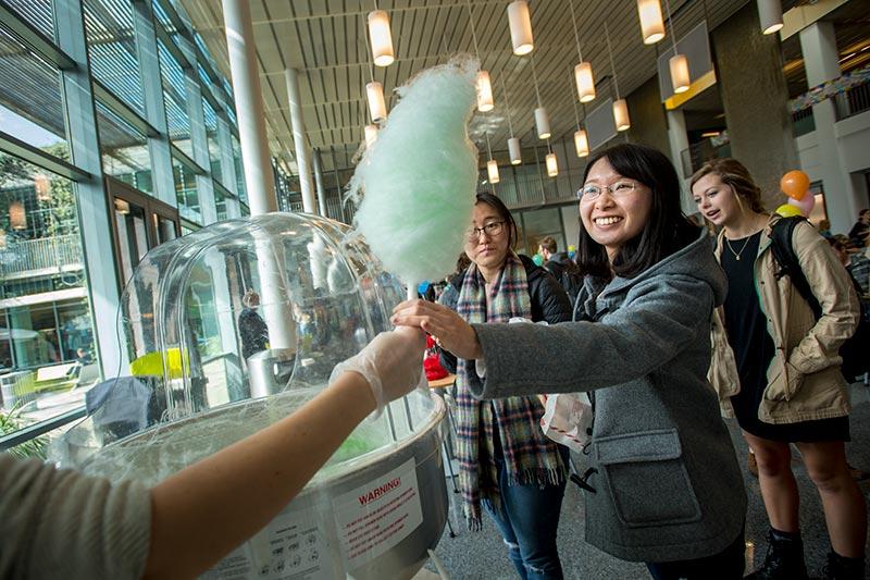 After a brief wait in line, Jingchen Xu reaches for the prized sugar-on-a-stick: cotton candy. The Lavin-Bernick Center hosts a sweet celebration.