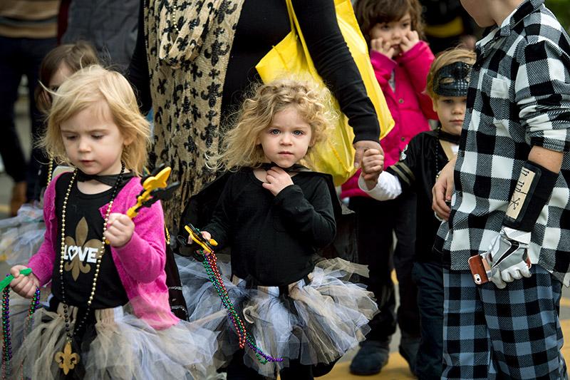 Members of the Lil’ Saints, one of several sub-krewes, makes its way through the crowd. Krewe of Newcomb rolls through the uptown campus spreading carnival cheer.