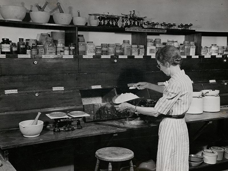 Sadie Irvine measures ingredients for a compound in the Newcomb Pottery studio. 