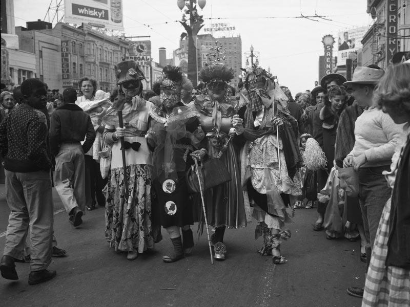 Four women stroll down Canal Street in homemade costumes on Mardi Gras day, 1954. 