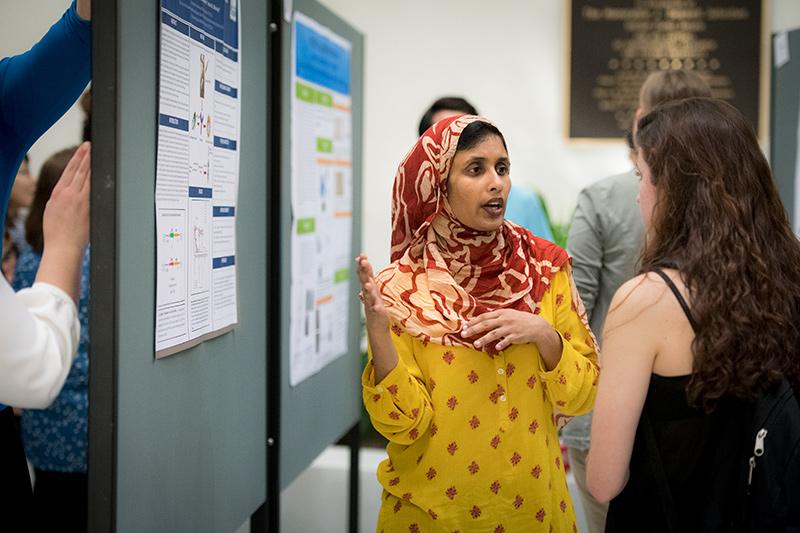 Summer Siddiqui, a pathology post doc in the lab of Binhua Ling, shares her research on developing improved options for the treatment of HIV. Researchers come together for annual health science poster presentations.