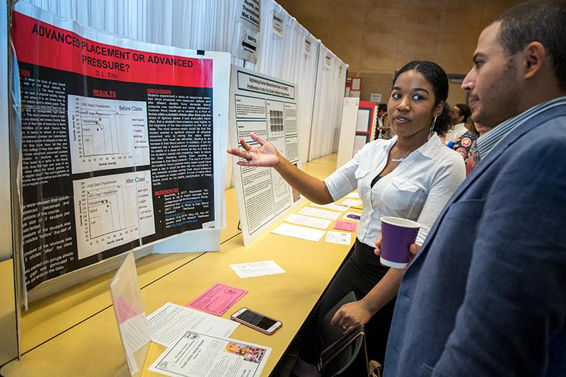 Dr. Mohamed Ghonim, right, listens as Darreille Ellis discusses her research regarding the stress levels of high school students enrolled in advanced placement (AP) courses at the 2018 Greater New Orleans Science and Engineering Fair on Wednesday (Feb 28) Young scientists converge on the uptown campus for annual science and engineering competition.