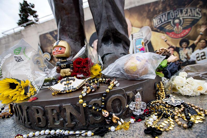 A makeshift memorial expands at the base of the statue. Benson, a native son and owner of the Saints and the New Orleans Pelicans, died on Thursday afternoon due to complications from the flu.