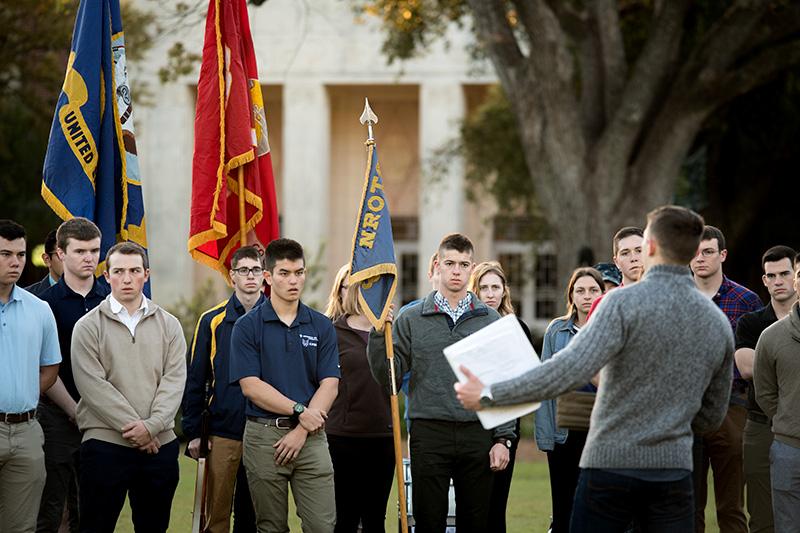 Midshipman Jacob Marvell gives words of encouragement before dismissal for spring break. Navy ROTC students practice for annual promotion ceremony.