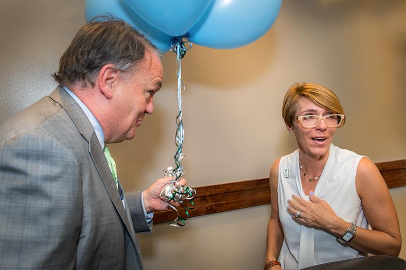 President Fitts surprises Kelly Venable Carroll with the award, and a balloon bouquet. President Fitts surprises outstanding employees with special delivery.