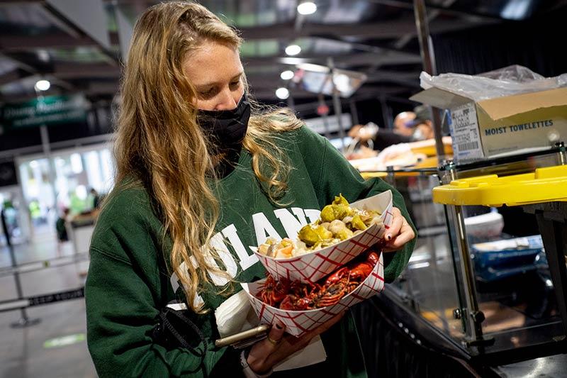 First-year student Sophie Jacobs balances generous servings of crawfish and vegetables. First-year student Sophie Jacobs balances generous servings of crawfish and vegetables.