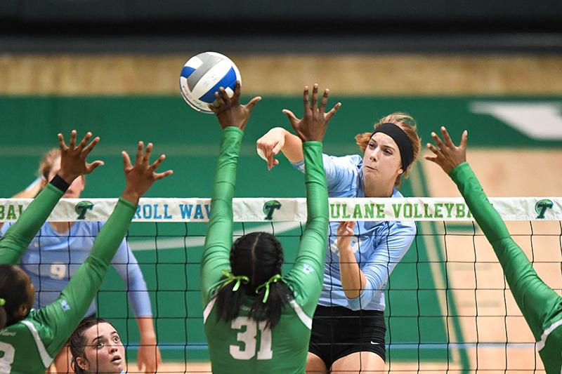 Friendly competition enhances teamwork during Green Wave volleyball scrimmage.