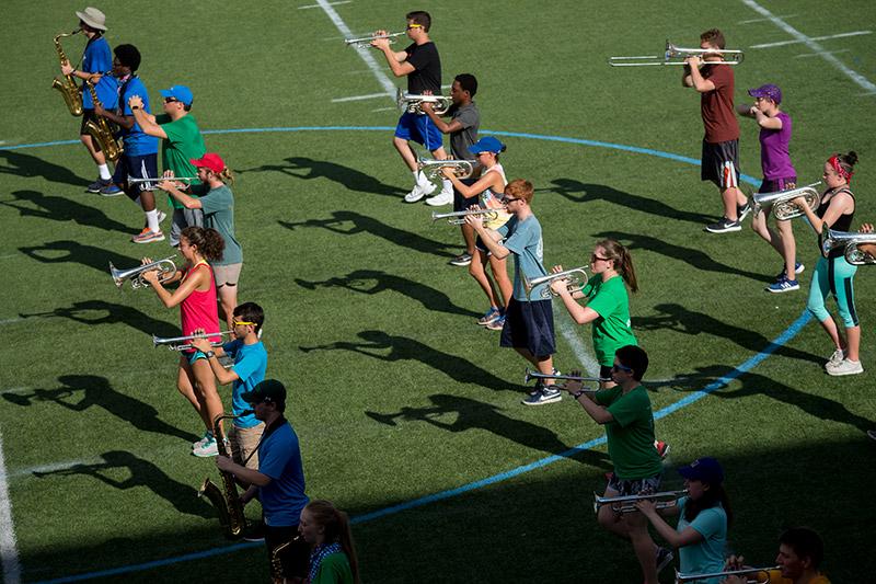 Band members concentrate on form and movement as they march to the beat of the drums. The Tulane University Marching Band (TUMB) braves the August heat and humidity to practice marching basics during the annual band camp on Brown Field.