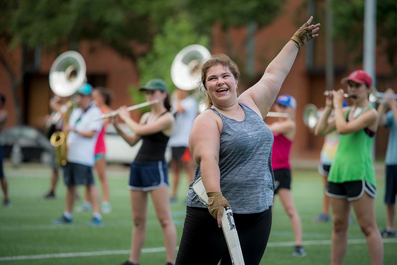 Tulane senior Casey Kotowski, a member of the color guard, aces the rifle routine. The Tulane University Marching Band (TUMB) braves the August heat and humidity to practice marching basics during the annual band camp on Brown Field.