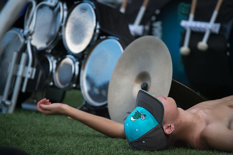 Drummer George Pratt takes full advantage of a hard-earned break. The Tulane University Marching Band (TUMB) braves the August heat and humidity to practice marching basics during the annual band camp on Brown Field.