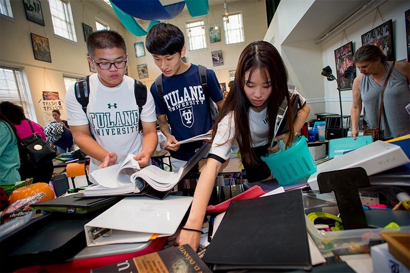 Zekun “Sam” Wu, Juncheol “Tony” Kim and Janie Park, left to right, search through a pile of books and binders at the Trash to Treasure sale in McWilliams Hall. A successful move-in is a well choreographed dance with boxes, bins and books.