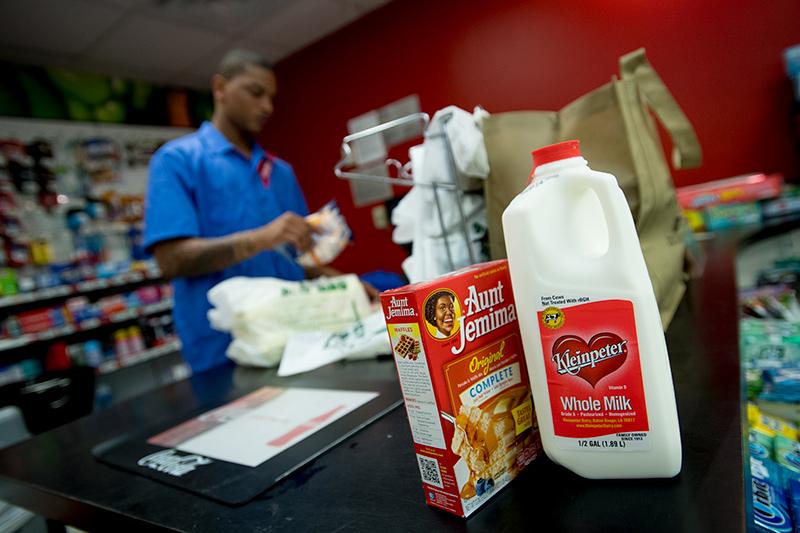 Nicholas Stewart rings up groceries in McAlister Market. The top-selling items for the day: water, chips and ice cream. Members of the Tulane community took advantage of a day off Tuesday due to possible heavy rain and flooding from Harvey.