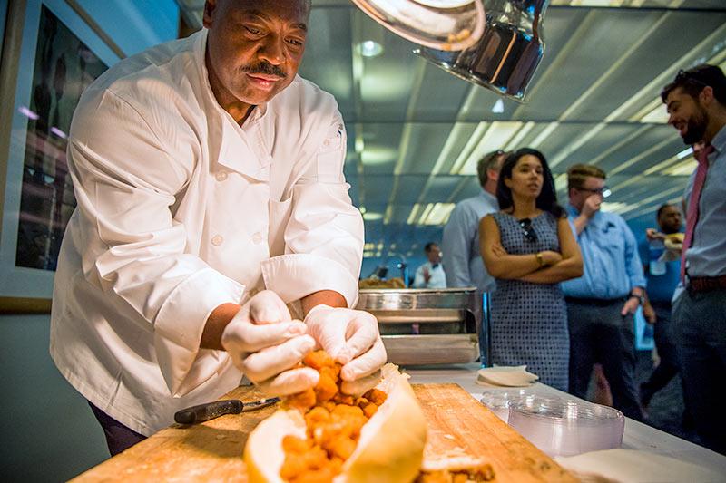 Po-boys with the President event brings grub and gab to members of the faculty and staff. Michael Camper, a chef with Sodexo Dining Services, prepares a shrimp po-boy on a full loaf of Leidenheimer french bread for the event.
