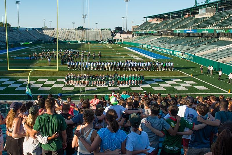 Students band together in the stands to learn the Green Wave fight song in preparation for football season. Yell For Yulman introduces first-year students to the Tulane football team and Green Wave spirit.