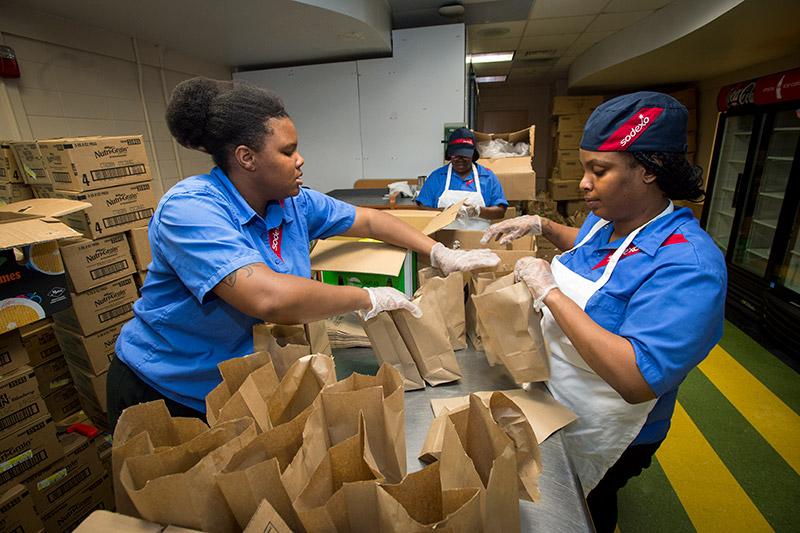 Sodexo staff members Courtney Shorts, Josette Neveaux, and Ashley Brown, left to right, work together to fill over 4,000 snack bags to be handed out to students across the uptown campus. As Tropical Storm Gordon approaches the Gulf Coast, the Tulane community takes the necessary precautions to ensure safety across campus.