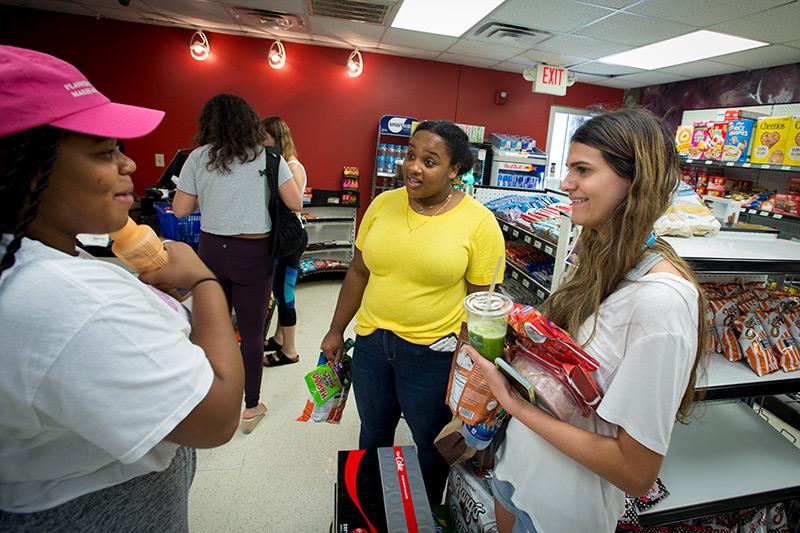 Lakia Williams, left, Leah Jackson, center, and Seanna Mohan, right, wait in line at McAlister Market to purchase last minute rations before heading to their dorm for the evening. As Tropical Storm Gordon approaches the Gulf Coast, the Tulane community takes the necessary precautions to ensure safety across campus.