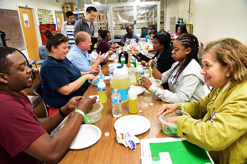 Middle school teachers chat while they mix slime — a staple in school science projects. Curiosity + fun = knowledge during the fall 2018 Boys At Tulane in STEM event.