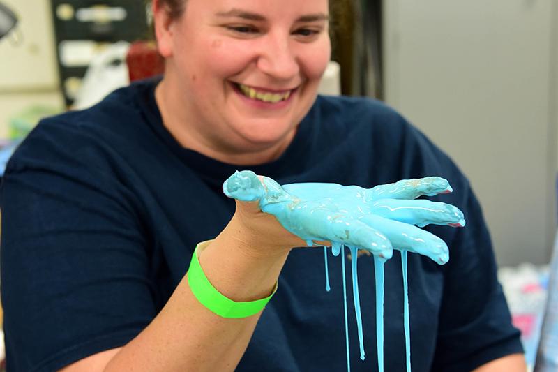 Gabrielle Constant, a teacher at Christian Brothers School, delights in the slime-making process. Curiosity + fun = knowledge during the fall 2018 Boys At Tulane in STEM event.