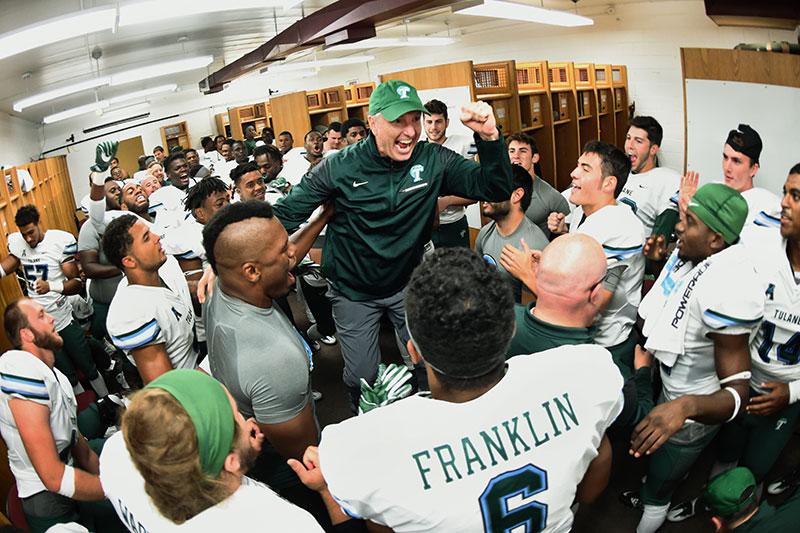 Head football coach Willie Fritz addresses his players after the  Wave’s come from behind 31-24 win over the Minutemen. 