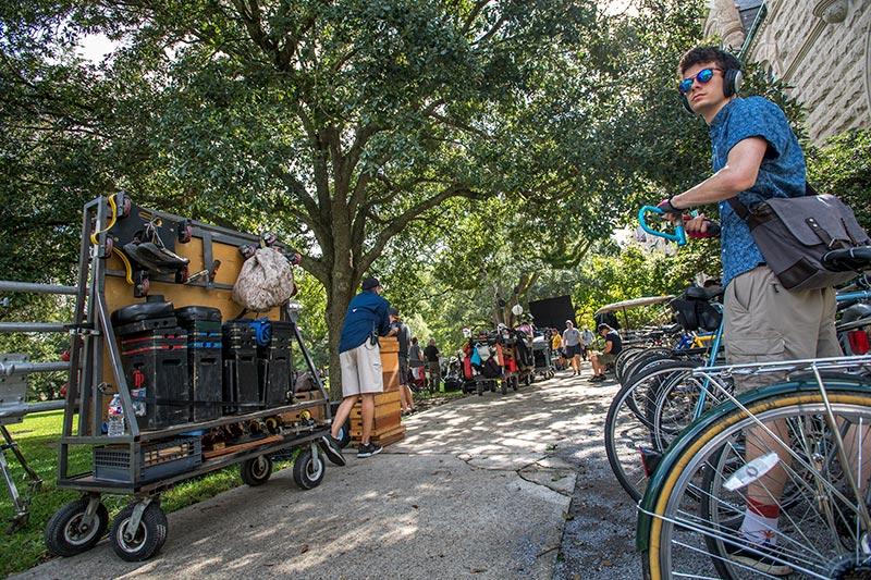 Tulane junior Eric Gerhardt Weiss scans the scene as he prepares to lock his bike outside Gibson Hall on his way to Government and the Economy class in nearby Tilton Hall. The uptown campus is cast as "Baronne University" in popular TV crime series.