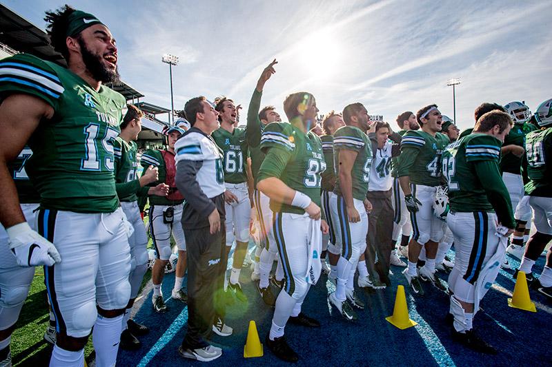 Green Wave players get pumped up with a sideline chant prior to kick-off. Homecoming brings together families, alumni