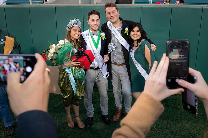 2018 homecoming queen Patch Rawanghet, far left, and king Julian Bourgeois, left, pose with last year’s royalty. Homecoming brings together families, alumni
