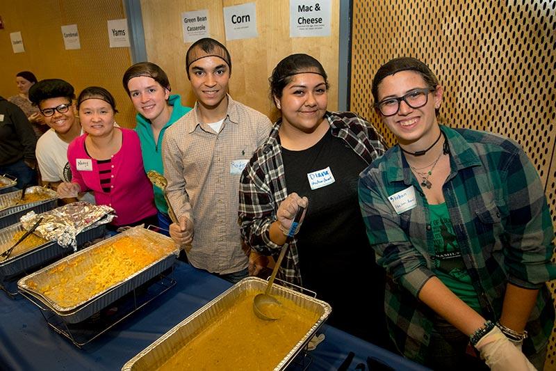Volunteers lined up to serve the traditional meal. The 2016 Pot Luck Thanksgiving Dinner featured food, fun and fellowship.