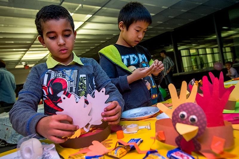 Elias Ahmed, left, and Harvey Ren work diligently to construct Thanksgiving themed headpieces. The 2016 Pot Luck Thanksgiving Dinner featured food, fun and fellowship.