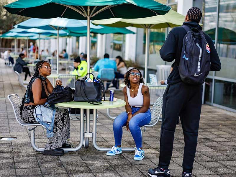 Students chat on the Gorson Porch at the Lavin-Bernick Center for University Life. 