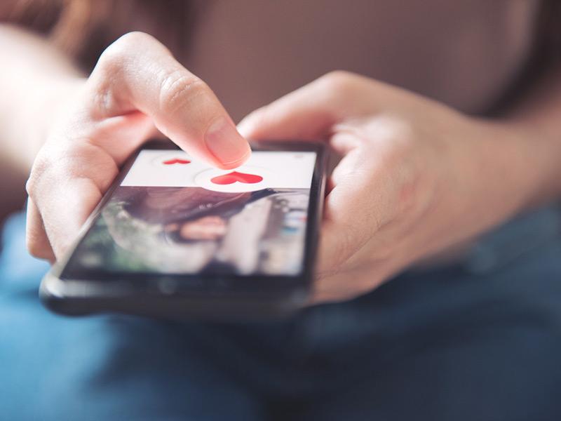 Dating app on a phone in hands