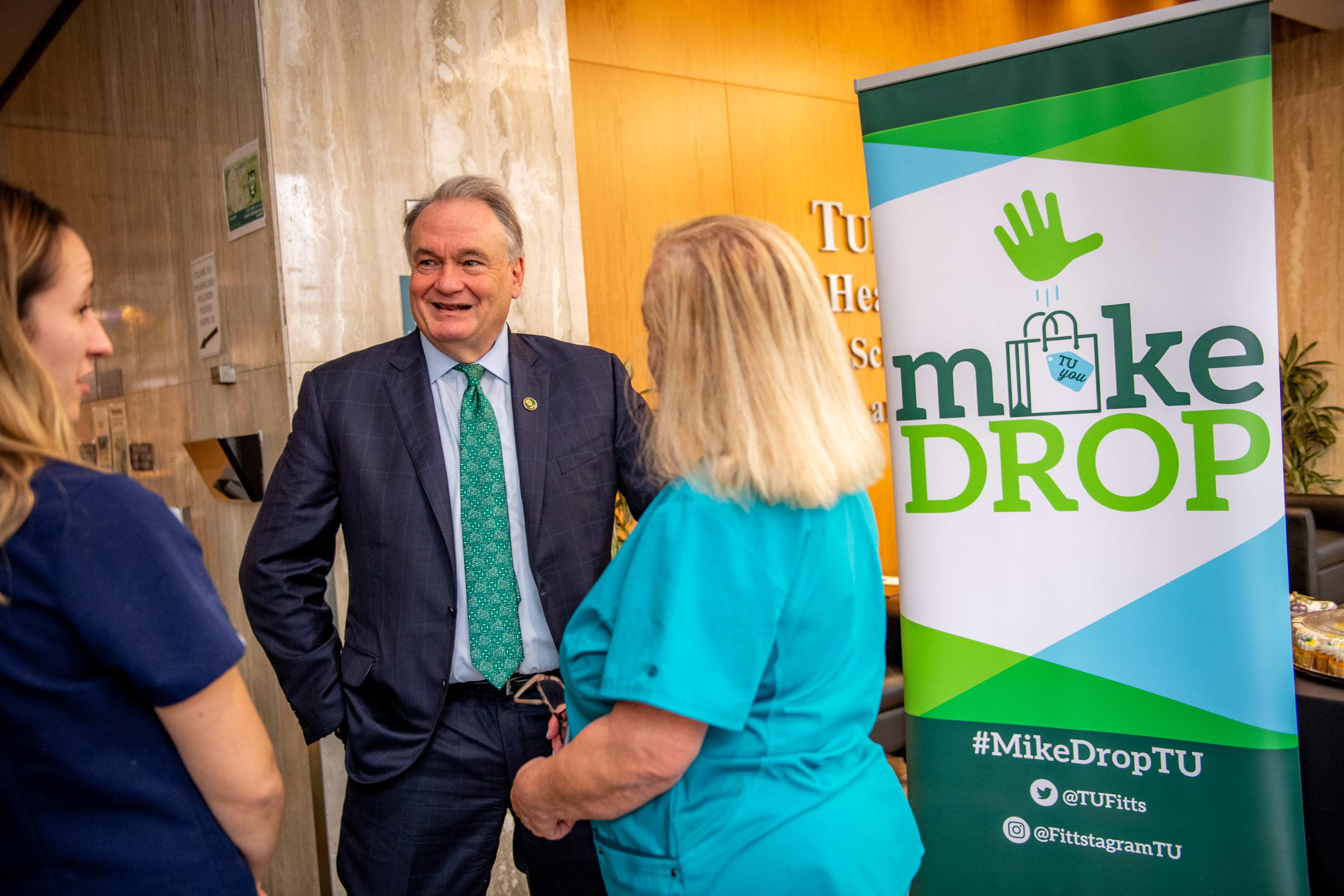 President Michael A. Fitts chatting with employees at a "MikeDrop" event in the Tidewater Building.