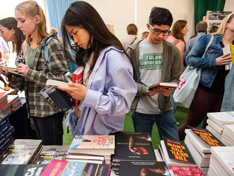 Attendees, including many Tulane students, browse books for sale by featured festival authors.