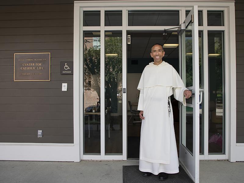 Rev. Ian Bordenave, O.P. stands in front of the Center for Catholic Life